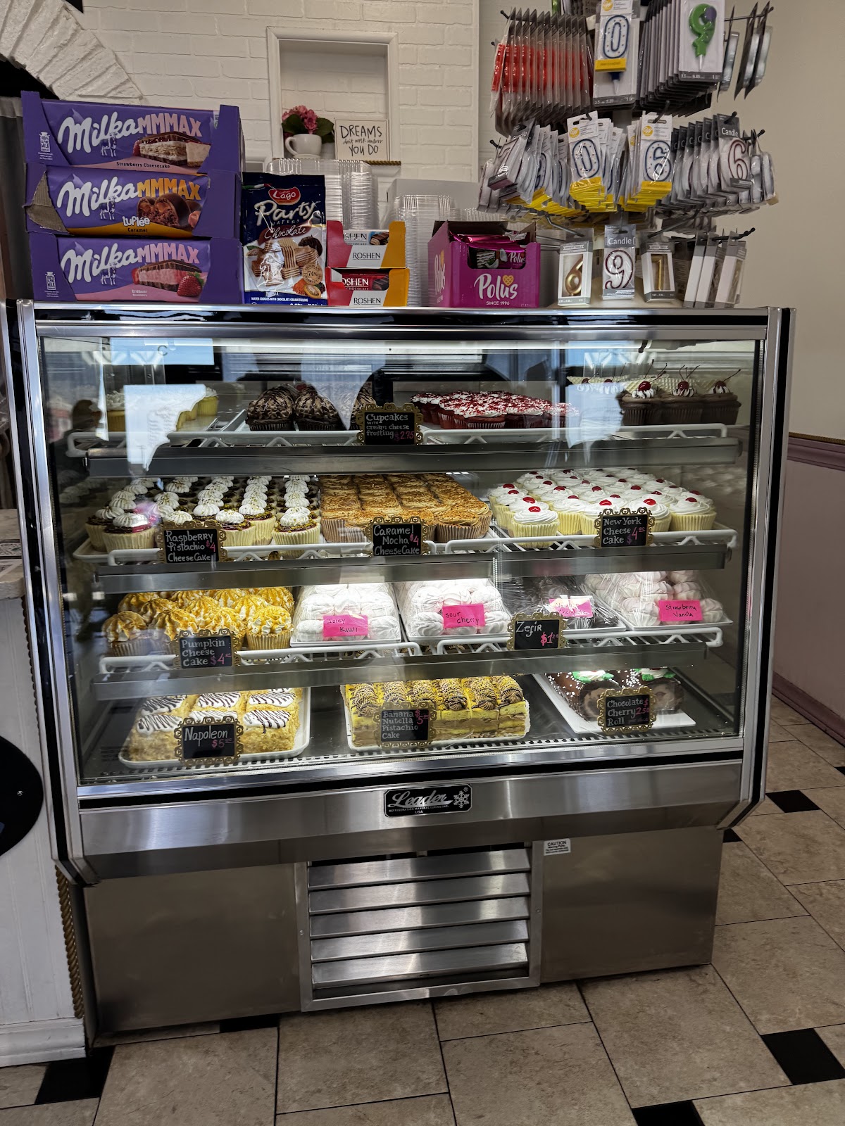 The bakery display case at Aliona's Euro Bake full of cakes, cheesecakes and pastries